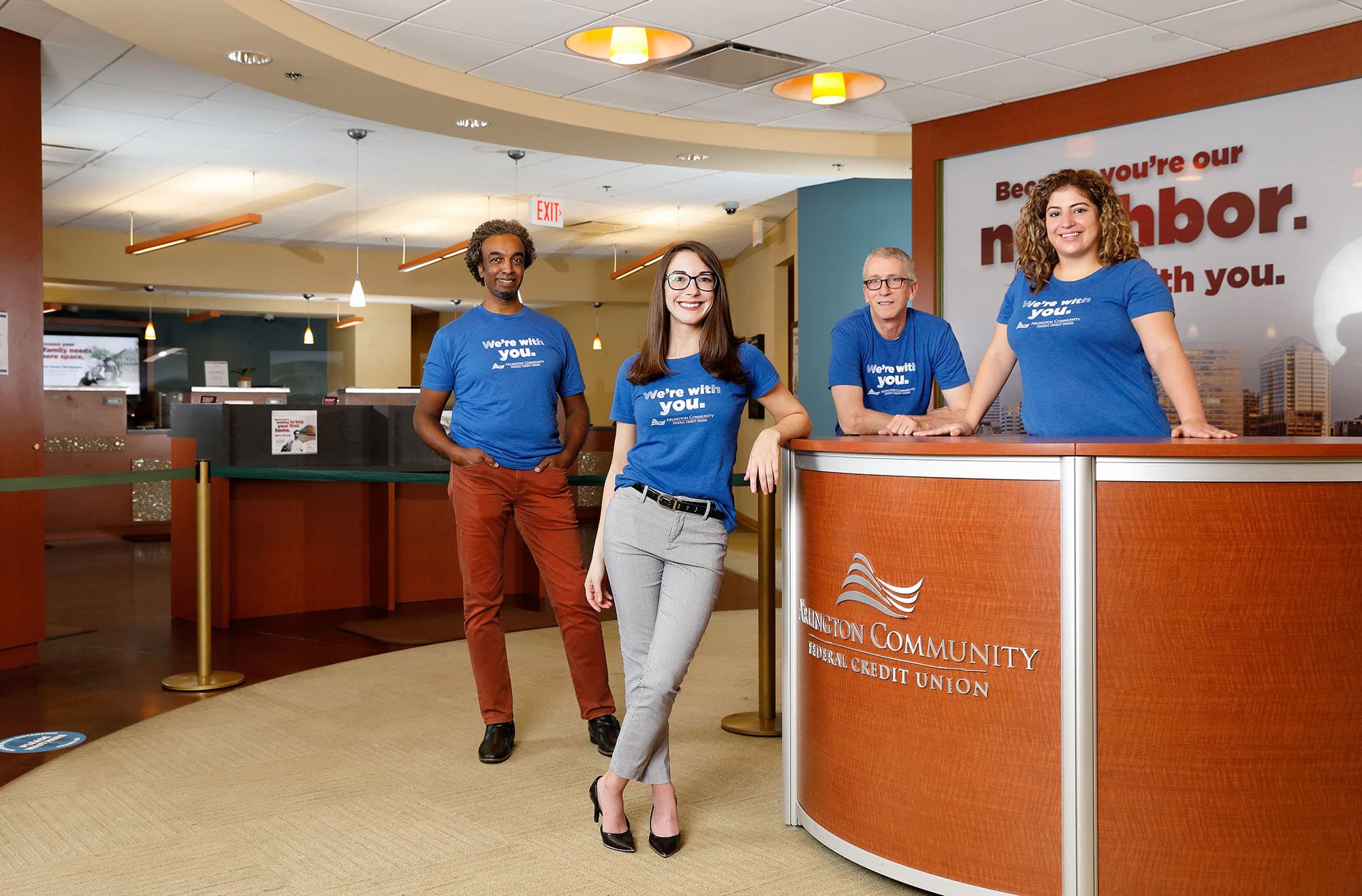 Inside the Arlington Credit Union office with staff standing by the front desk